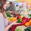 Girl shopping for produce at farmer's market with plant-based diet grocery list