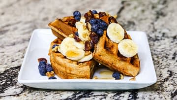 Spelt waffles with maple syrup, banana, blueberry, dates and walnuts