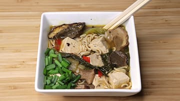 Spicy ramen noodles with tofu and mushrooms - vegan served in the white plate