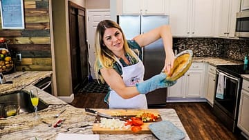 Caitlin Havener holding a garbanzo bean pie crust in her kitchen