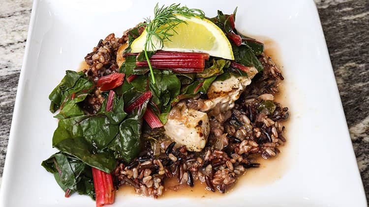 Swordfish served on top of the brown rice, with some greens and piece of lemon
