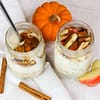 two jars full of overnight oats and pumpkin on the side