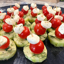 cucumber bites served on a black plate