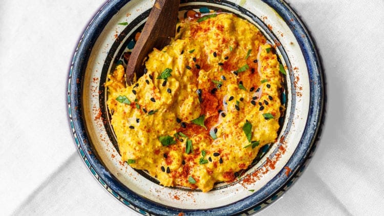 curry hummus served in a traditional bowl from Moroco