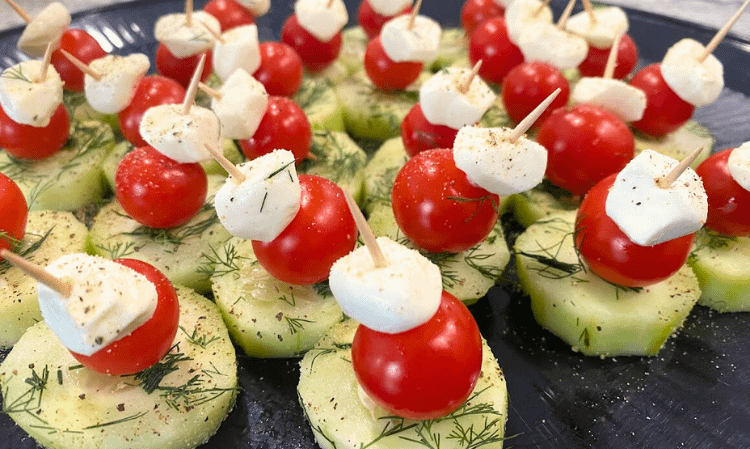 cucumber bites served on a black plate