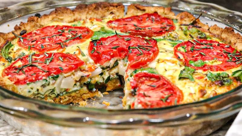 Tuscan Quiche served in the glass bowl with tomatoes on the top