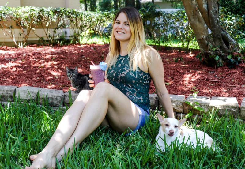 Sipping a kombucha smoothie while hanging out with the cat and dog