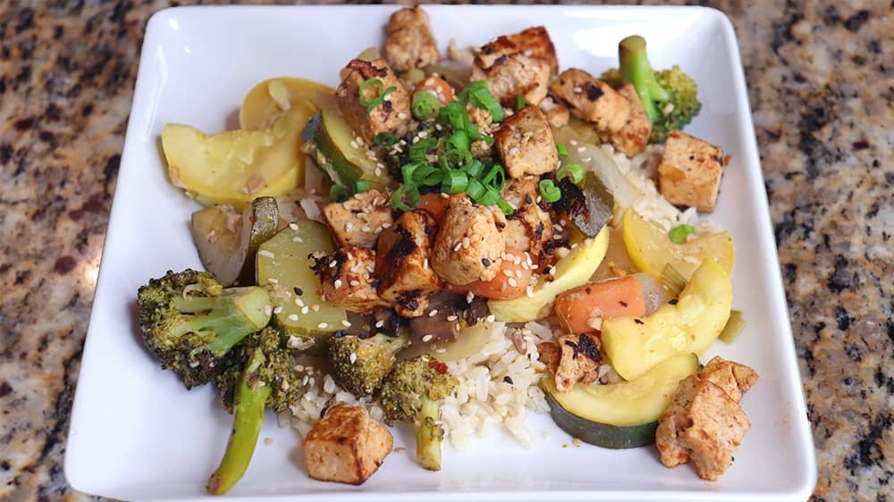 White plate with Asian tofu stir fry