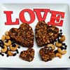 Valentine's heart shaped Cherry chocolate cashew date energy bars served in the white plate