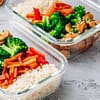 two glass bowls filled with rice,carrots,brocolli