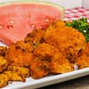 air fryer crispy buffalo cauliflower next to watermelon and yuka fries