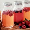 second fermentation of kombucha flavors,glass jars filled with raspberry, blueberry and strawberry kombucha