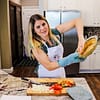 Caitlin Havener holding a garbanzo bean pie crust in her kitchen