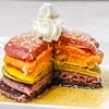 rainbow pancakes served with whipped cream and maple syrup
