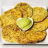 fried green tomatoes served on a white plate with some guacamole in small white bowl