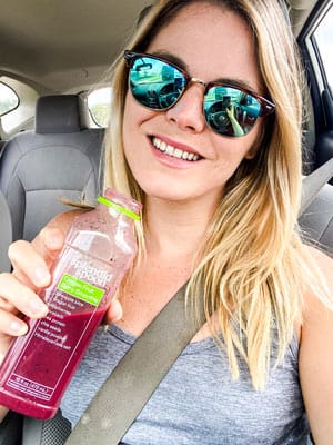 Me drinking the dragon fruit berry smoothie in the car on-the-go