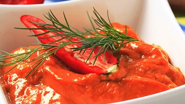 Red pepper coulis in a bowl close up