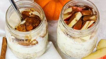 two jars full of overnight oats and pumpkin on the side