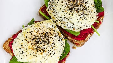Two toasts served on a white plate