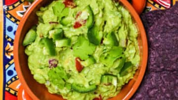tasty guacamole with tomatoes