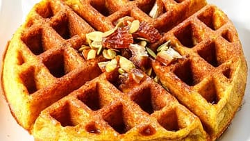 round pumpkin spice protein waffle served on a white surface