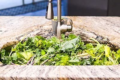 mixed greens in sink to be rinsed