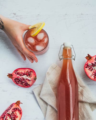 kombucha in a glass with pomegranates 