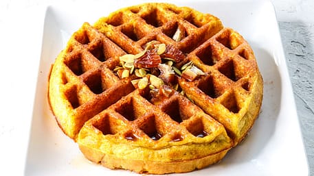 round pumpkin spice protein waffle served on a white surface