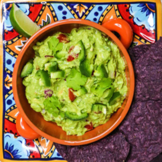 tasty guacamole with tomatoes