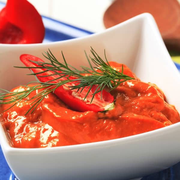 Red pepper coulis in a bowl close up
