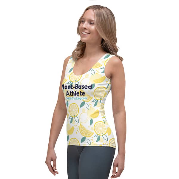 Female model in athletic shirt with yellow lemons, logo and inscription "Plant-based Athlete" CaitlinCooking.com