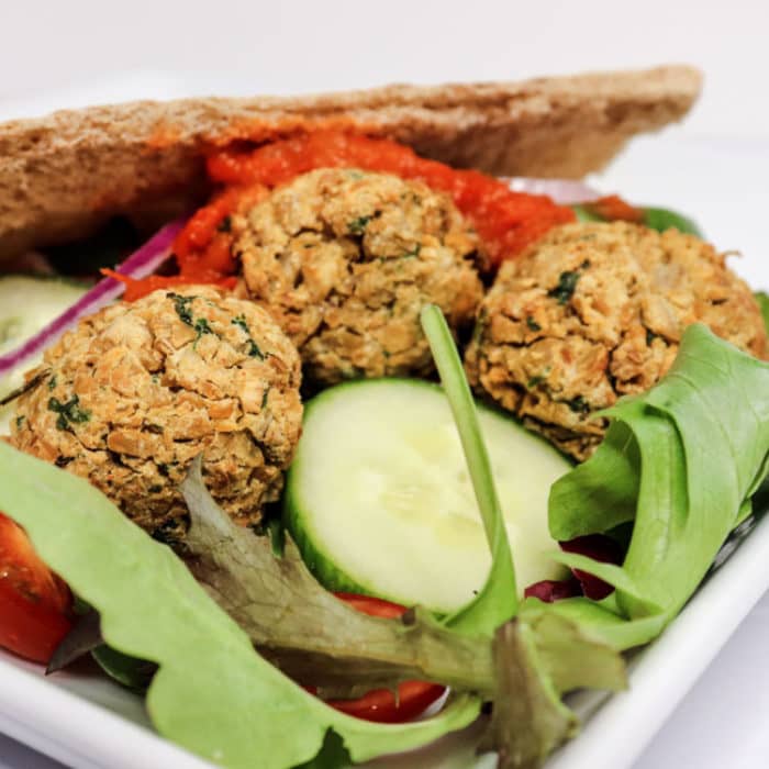 air fryer falafel nestled in a bed of salad in a gyro