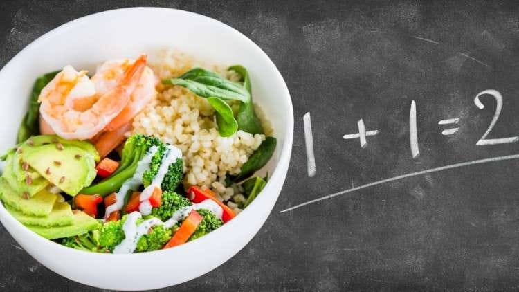 round white bowl filled with different vegetables, 1+1=2 written on the gray board