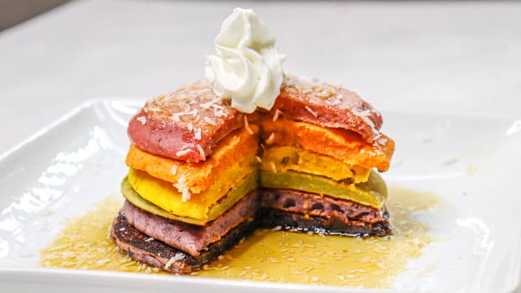rainbow pancakes served with whipped cream and maple syrup