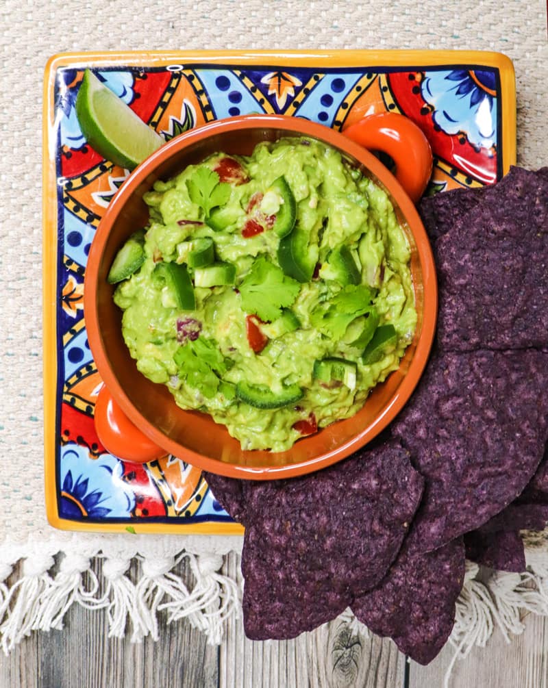 guacamole dip with tomatoes and green peppers