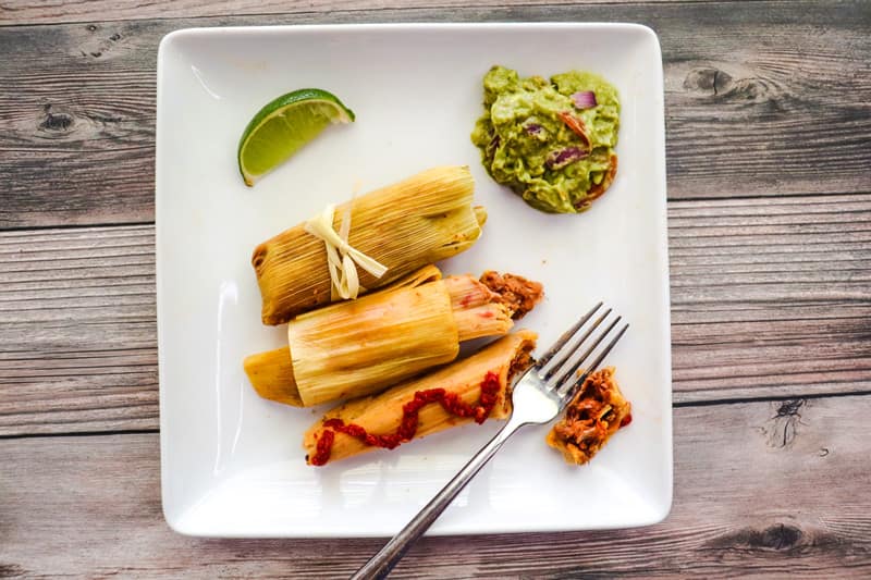 tamales and chili lime jackfruit carnitas on the white plate